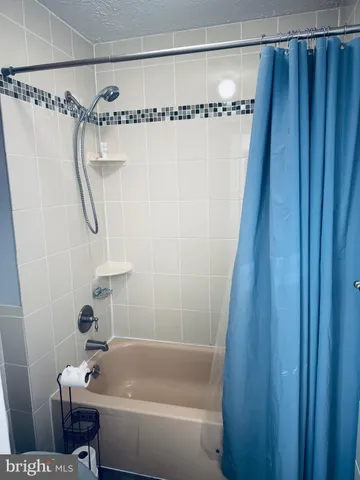a bathroom with a shower and a tub