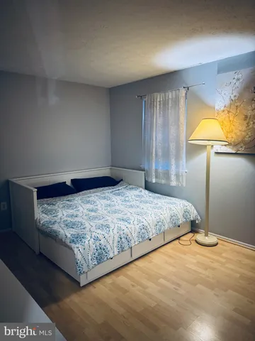 a large bed sitting in a room next to a lamp