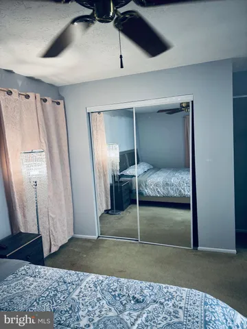 a bedroom with a bed and a rug