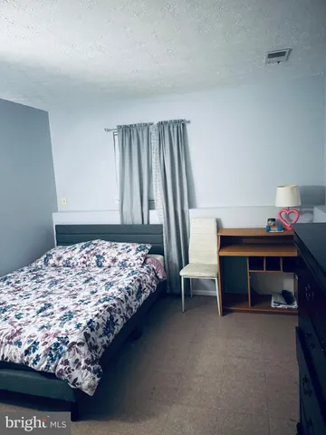 a bedroom with bed and a window