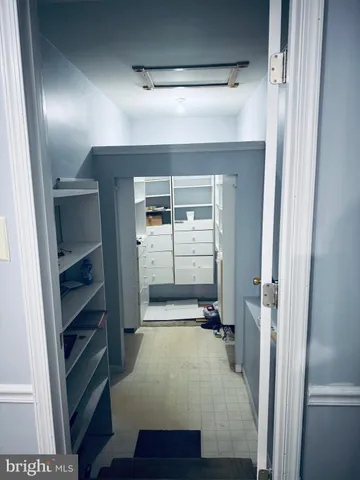 a view of a hallway with wooden floor and closet