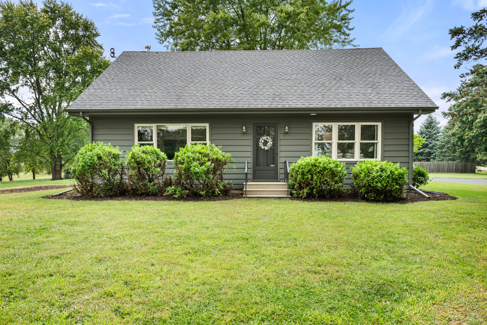 40w897 Brown Road St. Charles, IL 60175 - Photo 2 of 35 a front view of a house with a garden
