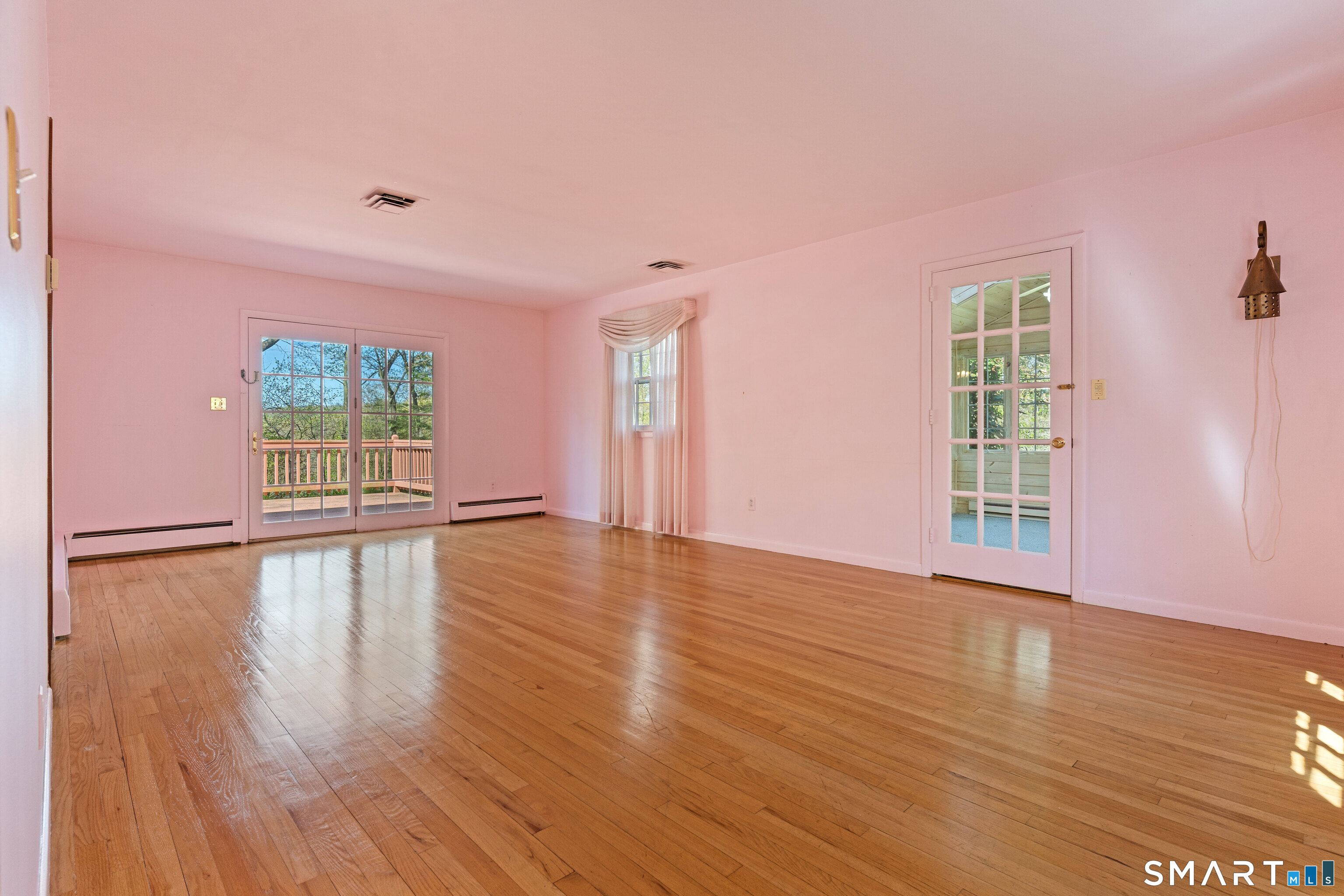 251 Shelter Rock Road Fairfield, CT 06825 - Photo 7 of 38 a view of empty room with wooden floor and fan
