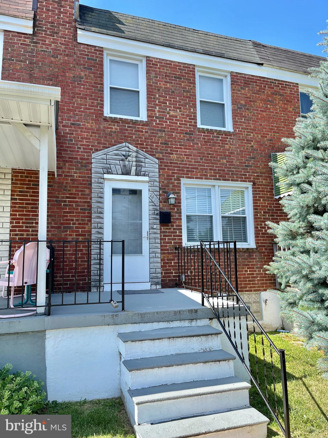 a front view of a house with glass windows and door