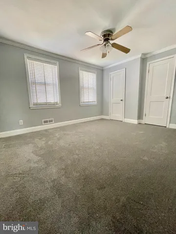 an empty room with closet and entryway