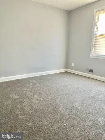 an empty room with closet and a bathroom