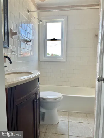 a bathroom with a toilet a sink and a mirror