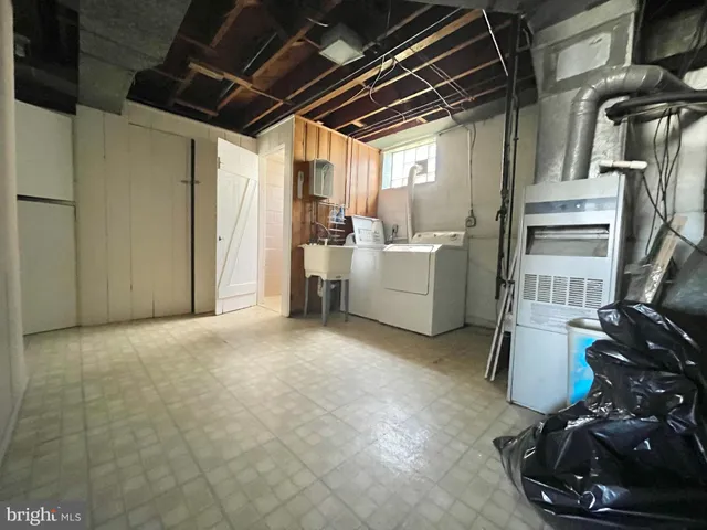 a large white kitchen with white cabinets and appliances