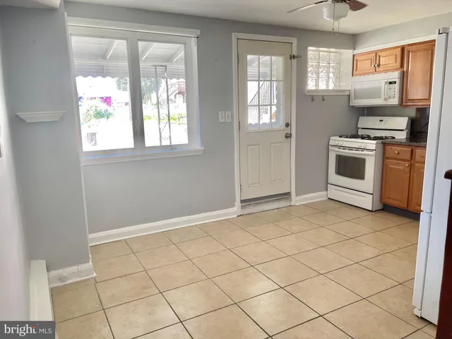 a white refrigerator freezer and a stove in a kitchen