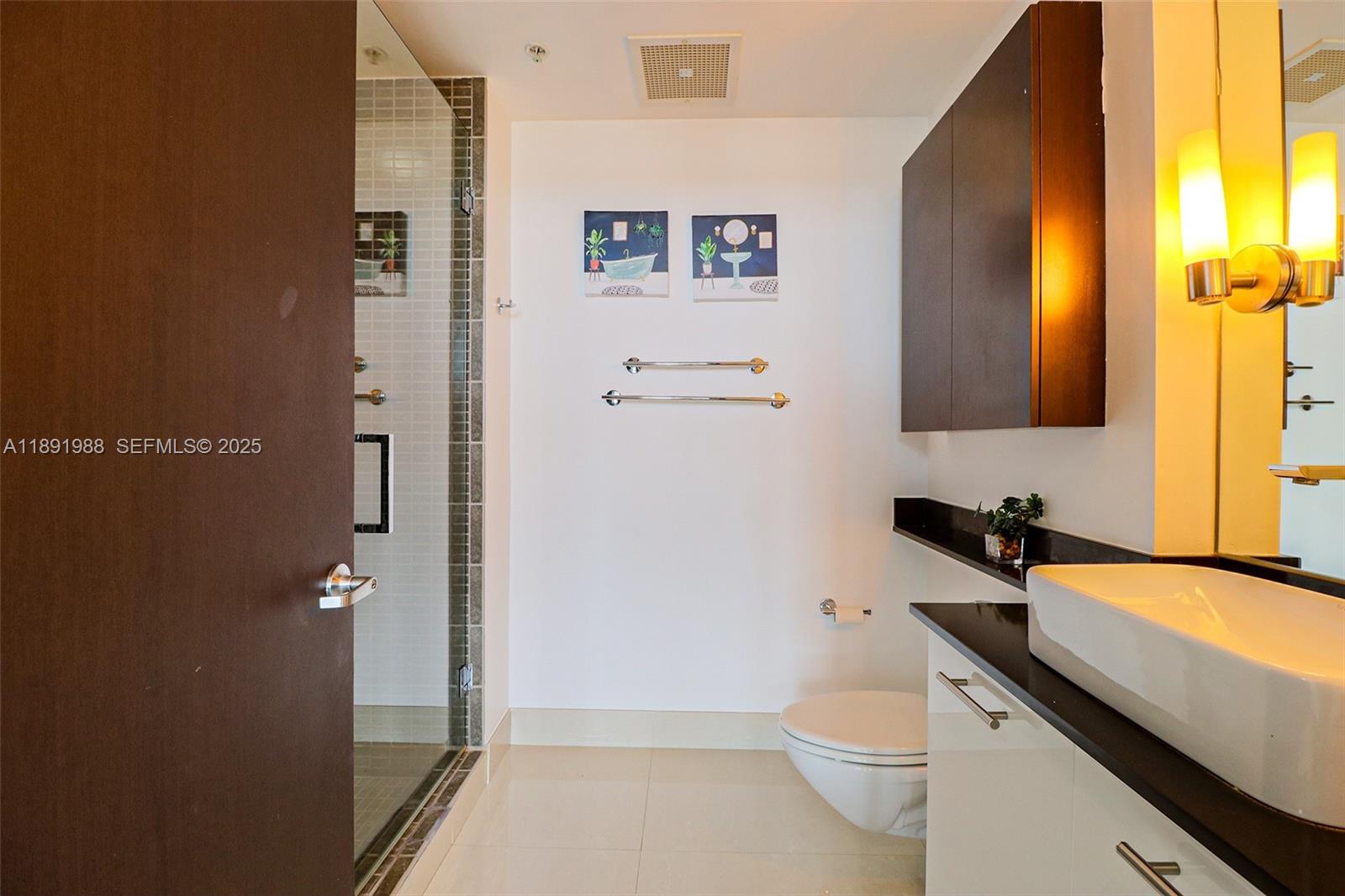 3451 Northeast 1st Avenue, Unit M0804 Miami, FL 33137 - Photo 24 of 39 a bathroom with a sink a toilet and a mirror