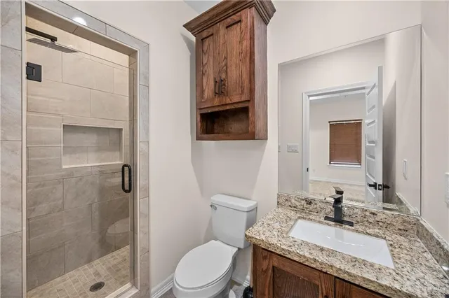 a kitchen with granite countertop wooden cabinets and refrigerator