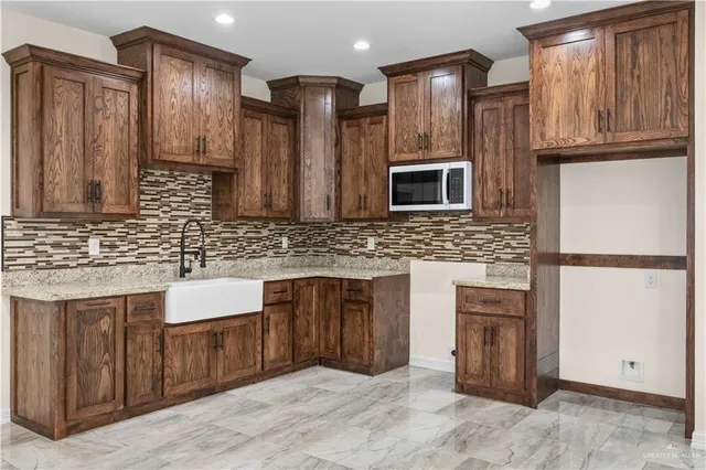 a kitchen with stainless steel appliances granite countertop a refrigerator and a sink