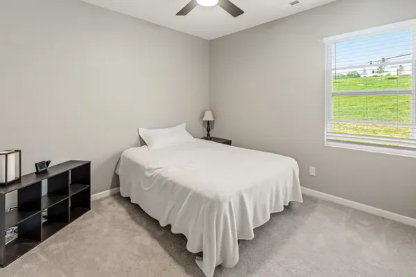 a bed room with a bed and a chandelier