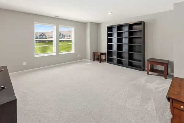 an empty room with a fireplace and window