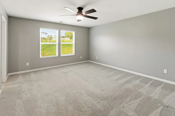 a view of room with a ceiling fan and window