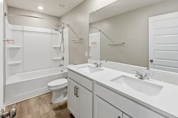 a bathroom with a double vanity sink mirror and shower