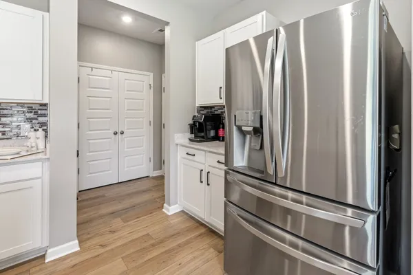 a kitchen with stainless steel appliances a refrigerator and cabinets