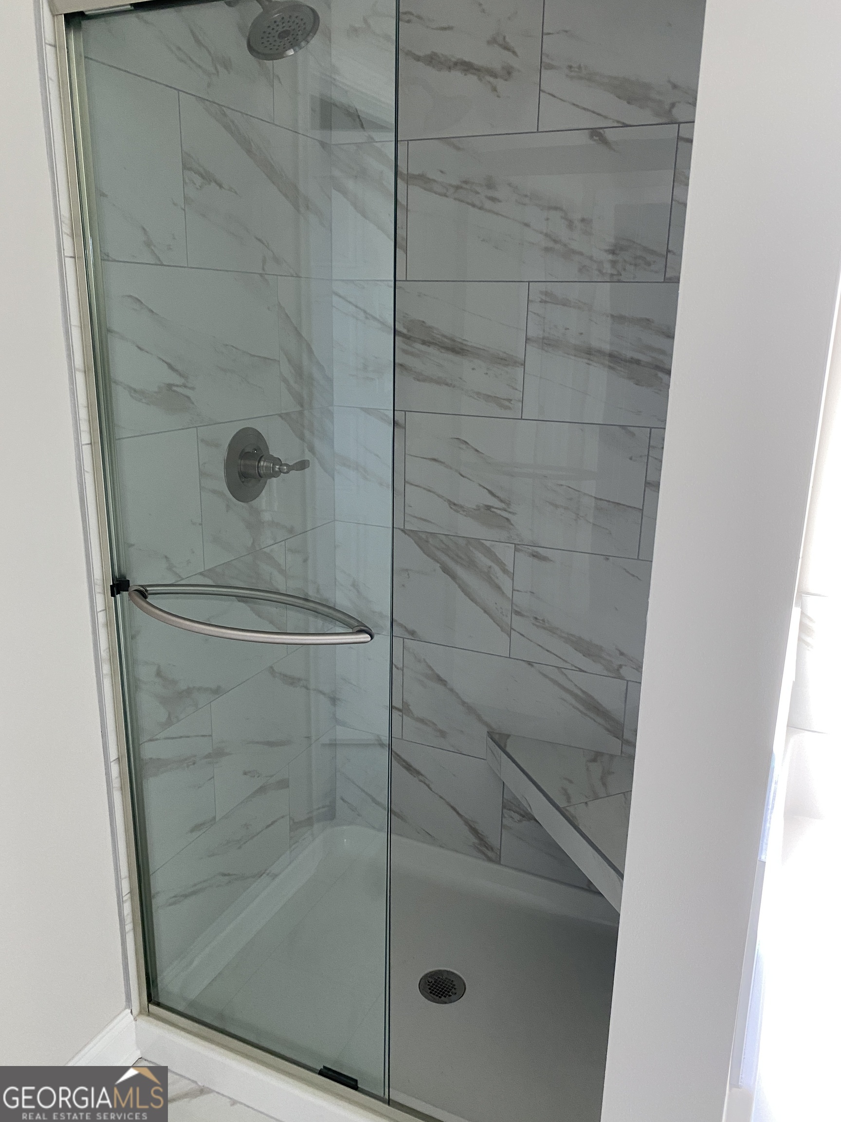 162 Delightful Way, Unit 28 Winder, GA 30680 - Photo 11 of 11 a bathroom with a glass door shower