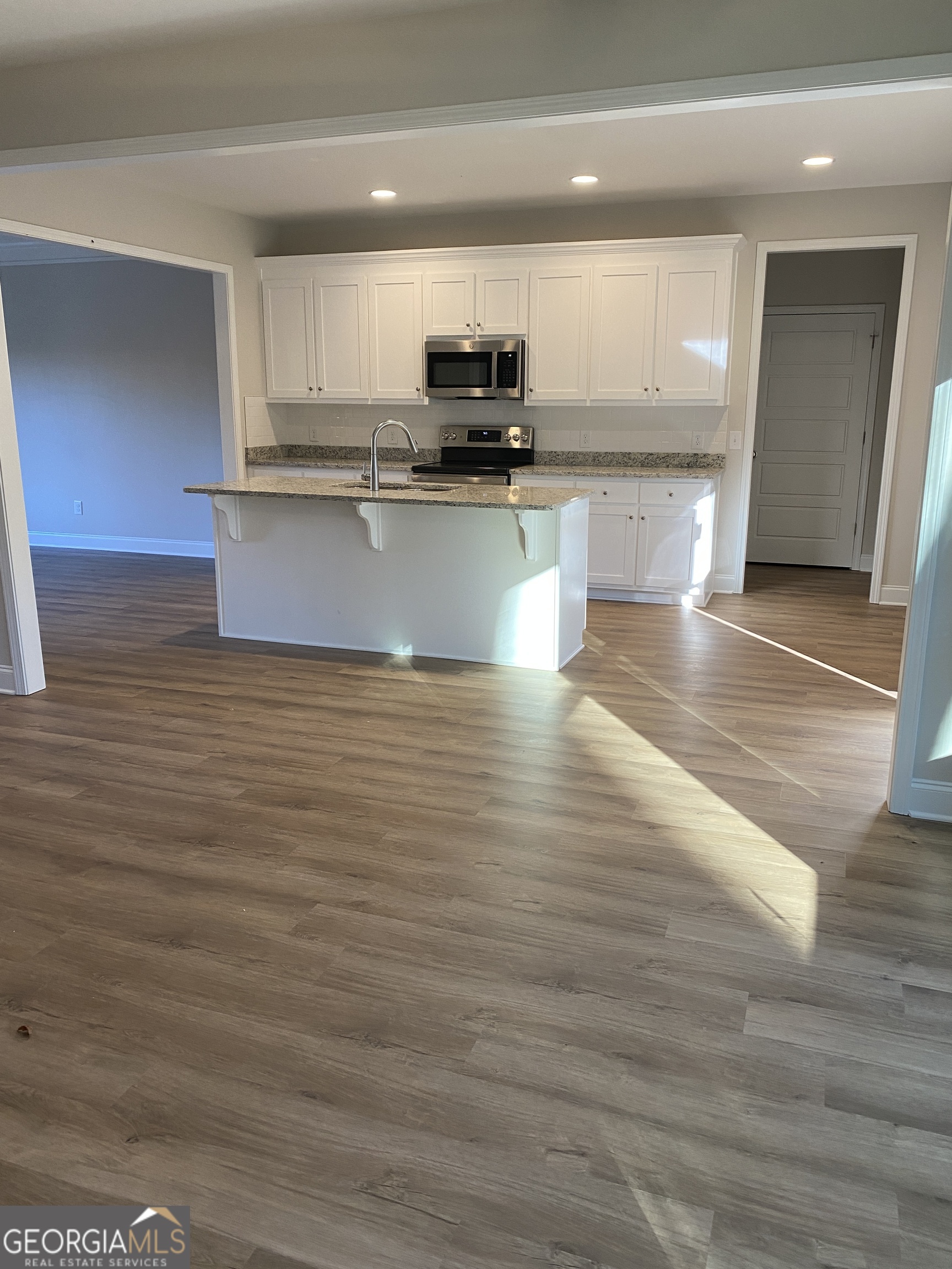 162 Delightful Way, Unit 28 Winder, GA 30680 - Photo 4 of 11 a view of kitchen with stainless steel appliances wooden floor and cabinets