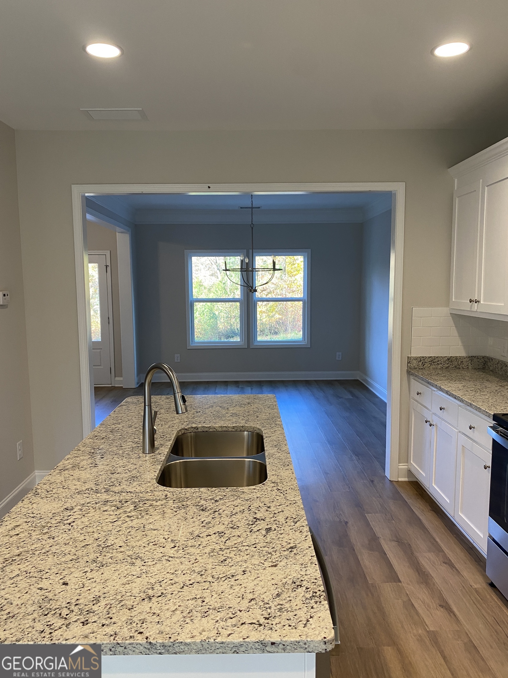 162 Delightful Way, Unit 28 Winder, GA 30680 - Photo 6 of 11 a kitchen with a sink a stove and cabinets