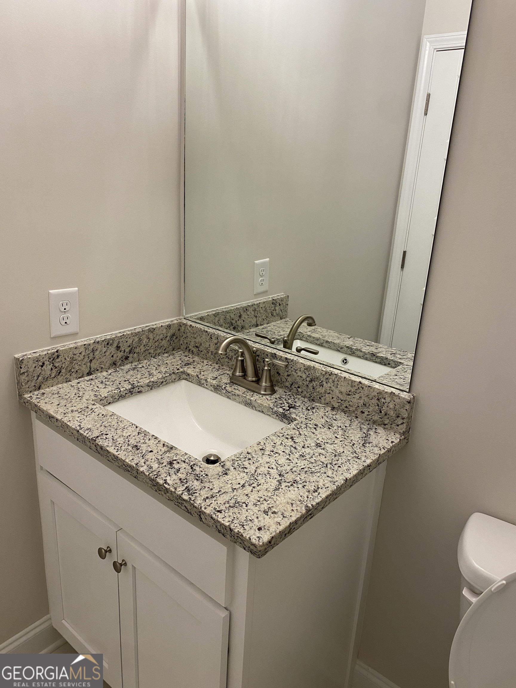 162 Delightful Way, Unit 28 Winder, GA 30680 - Photo 7 of 11 a bathroom with a granite countertop sink and a mirror