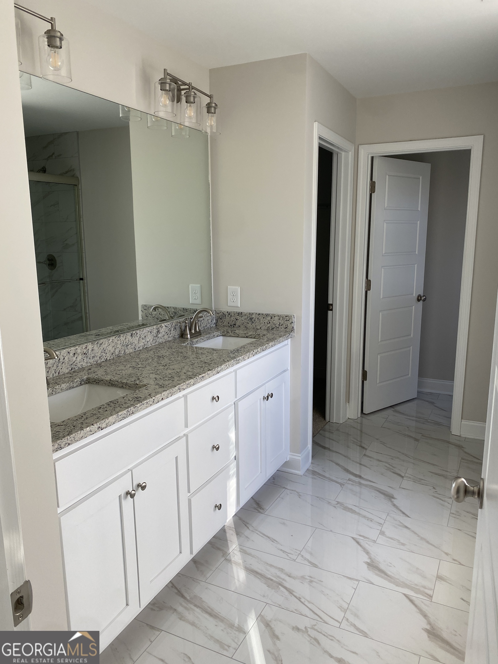 162 Delightful Way, Unit 28 Winder, GA 30680 - Photo 8 of 11 a bathroom with a granite countertop sink and mirror