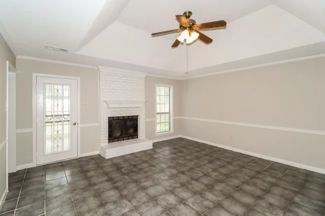 a view of a livingroom with a ceiling fan and window