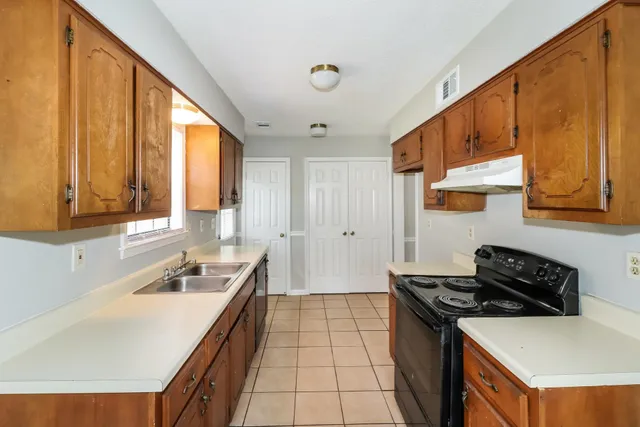 a kitchen with a sink a stove and a refrigerator