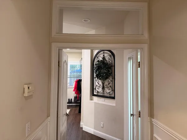 a front view of a house with wooden floor and hallway