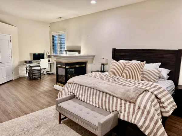 a bedroom with a bed and wooden floor
