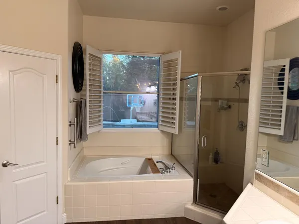 a bathroom with a bathtub and a shower