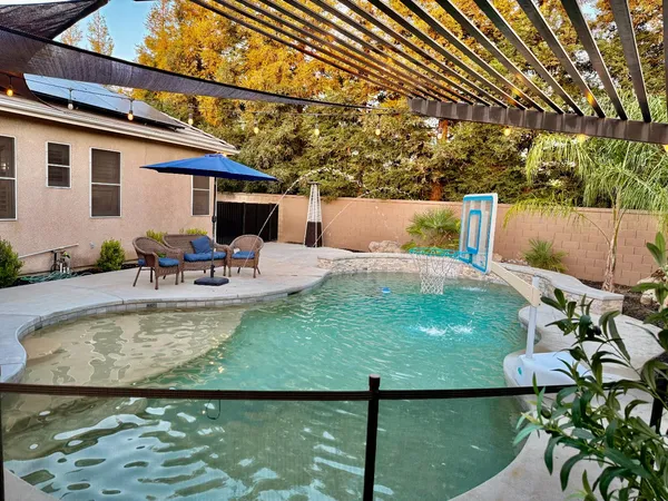 a backyard of a house with outdoor seating
