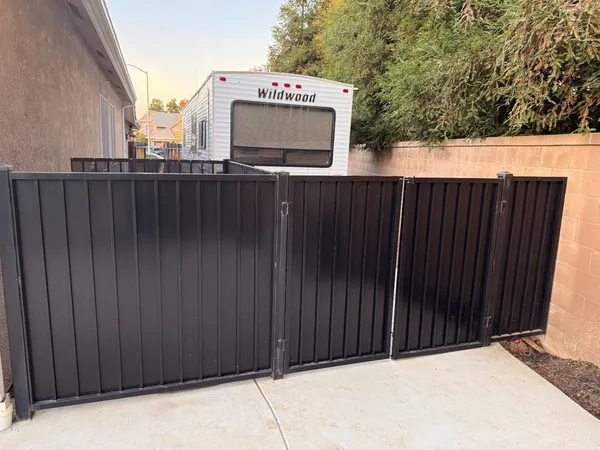 a backyard of a house with barbeque oven and a stove