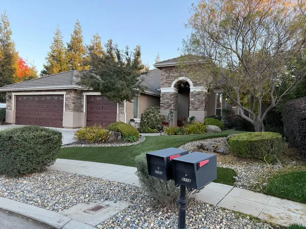 a front view of a house with porch and garden