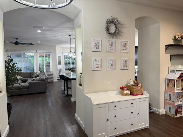 a living room with furniture and a wooden floor