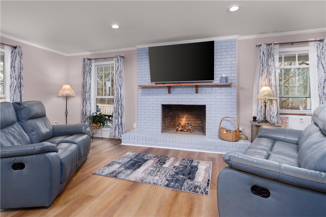 305 Farmdale Road Hodges, SC 29653 - Photo 13 of 48 This living room features a cozy brick fireplace, creating a warm and inviting atmosphere.
