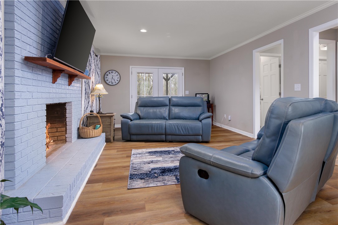 305 Farmdale Road Hodges, SC 29653 - Photo 14 of 48 This inviting living space features warm flooring and a cozy fireplace, perfect for relaxing.