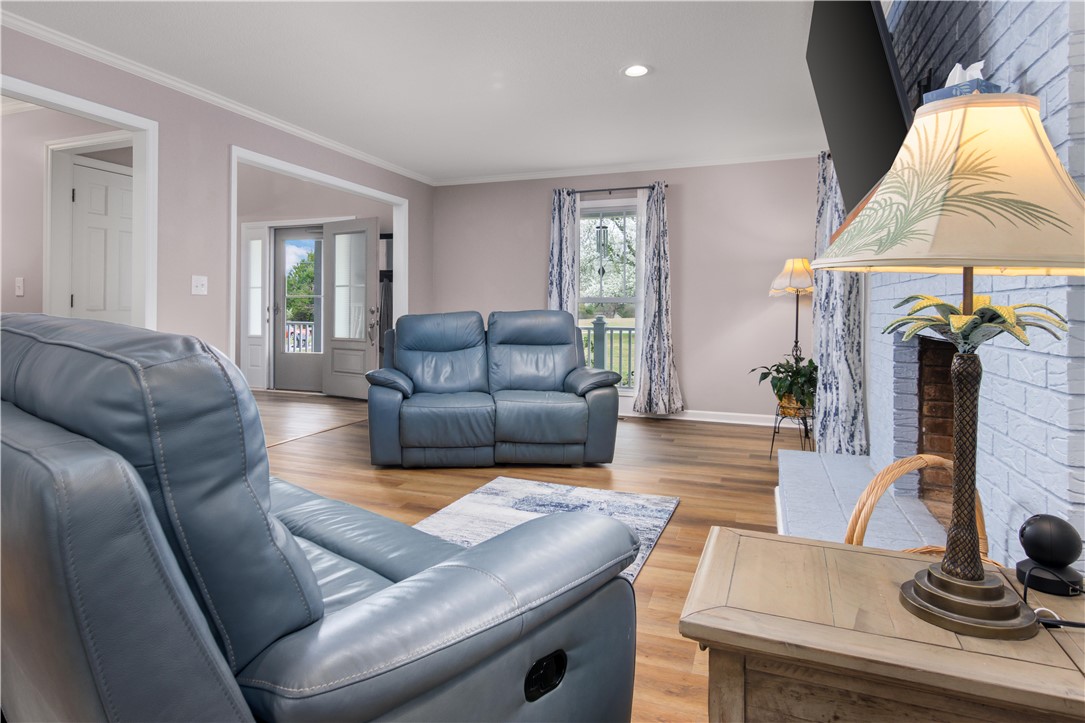 305 Farmdale Road Hodges, SC 29653 - Photo 15 of 48 This inviting living room features durable flooring and a cozy fireplace, perfect for gatherings.