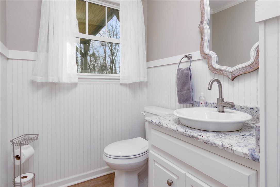 305 Farmdale Road Hodges, SC 29653 - Photo 17 of 48 This functional bathroom features a clean design with elegant granite counters and classic wainscoting.