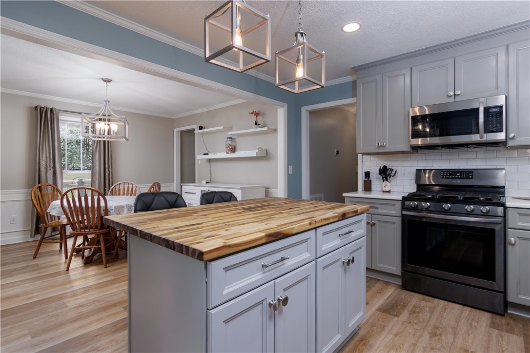 305 Farmdale Road Hodges, SC 29653 - Photo 19 of 48 This inviting kitchen features a central island, providing both functionality and a welcoming aesthetic for daily living.