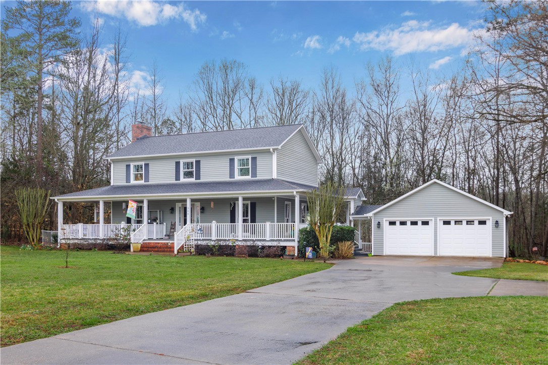 305 Farmdale Road Hodges, SC 29653 - Photo 2 of 48 This charming home features a wide front porch and a detached two-car garage, perfect for serene living.