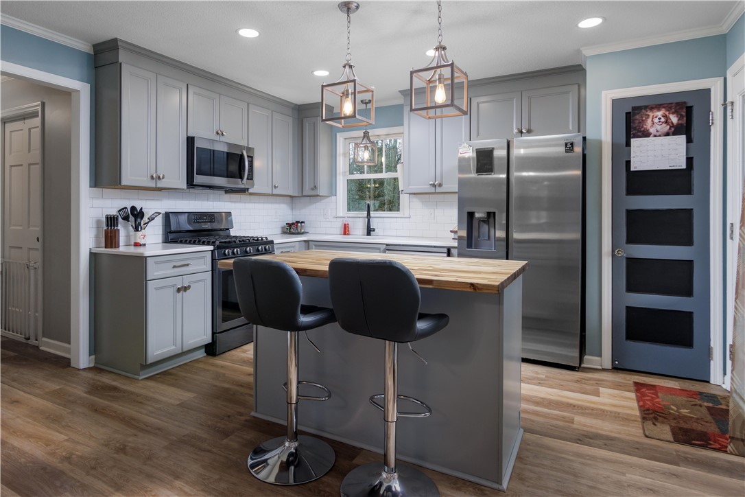 305 Farmdale Road Hodges, SC 29653 - Photo 20 of 48 This thoughtfully designed kitchen boasts ample counter space and modern amenities, ideal for culinary endeavors.