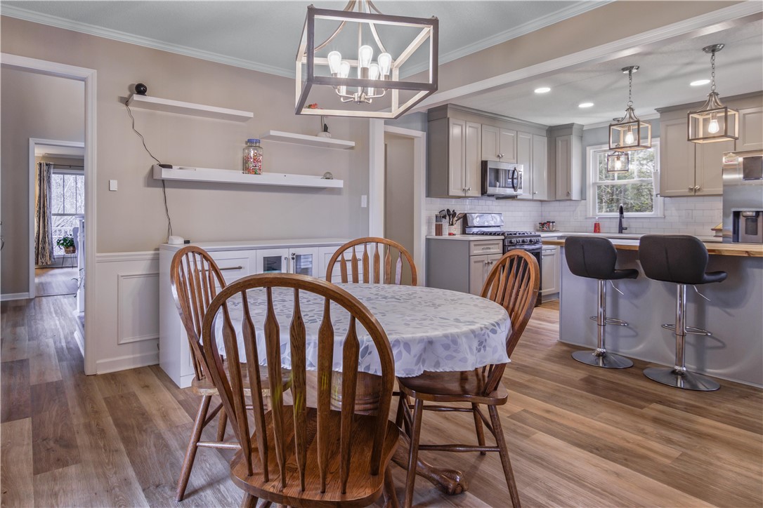 305 Farmdale Road Hodges, SC 29653 - Photo 21 of 48 This inviting dining area seamlessly connects to a contemporary kitchen, offering both functionality and style.