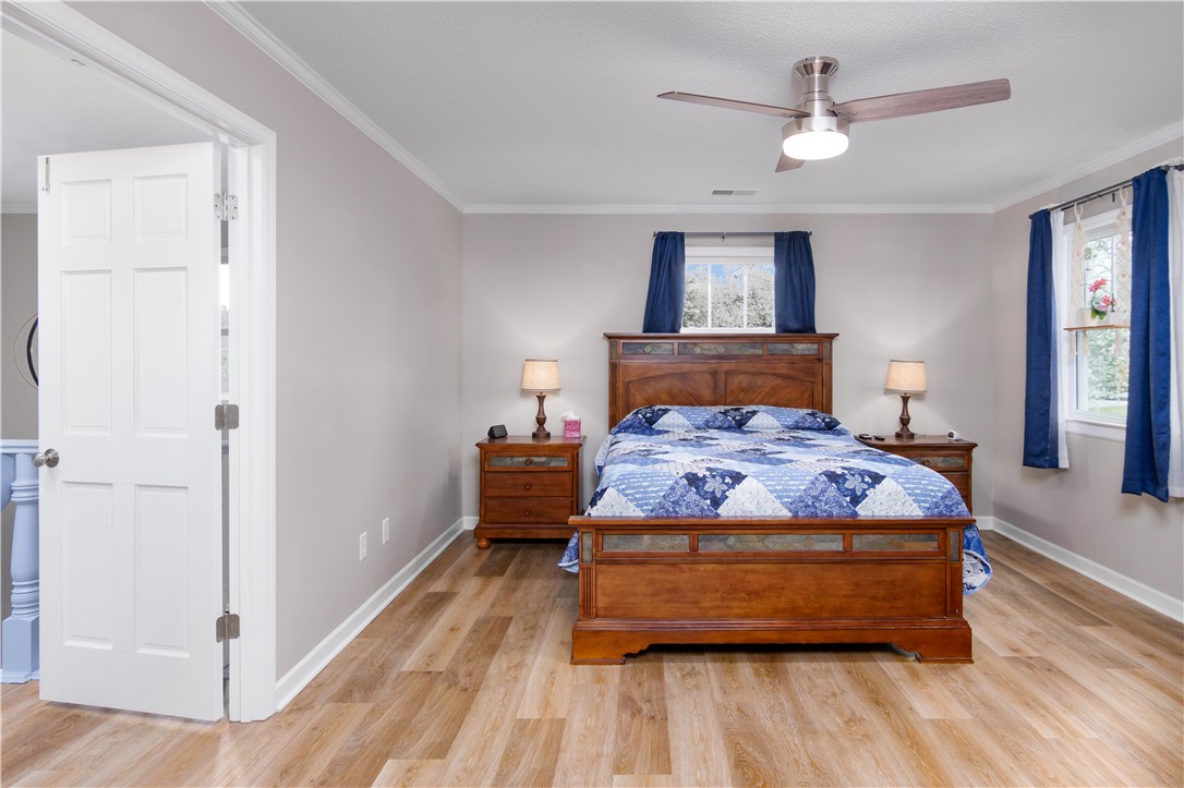 305 Farmdale Road Hodges, SC 29653 - Photo 23 of 48 This spacious room features ample natural light and warm wood flooring.