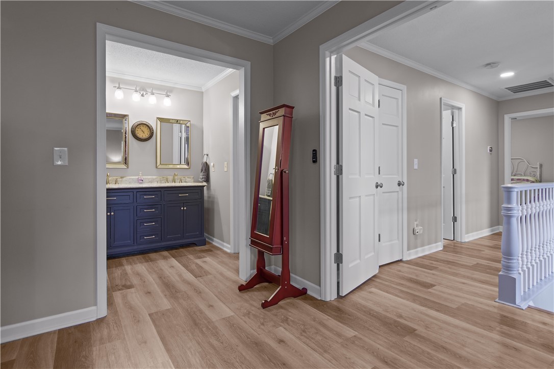 305 Farmdale Road Hodges, SC 29653 - Photo 25 of 48 This spacious hallway offers a harmonious flow, connecting various living spaces with ease and elegance.