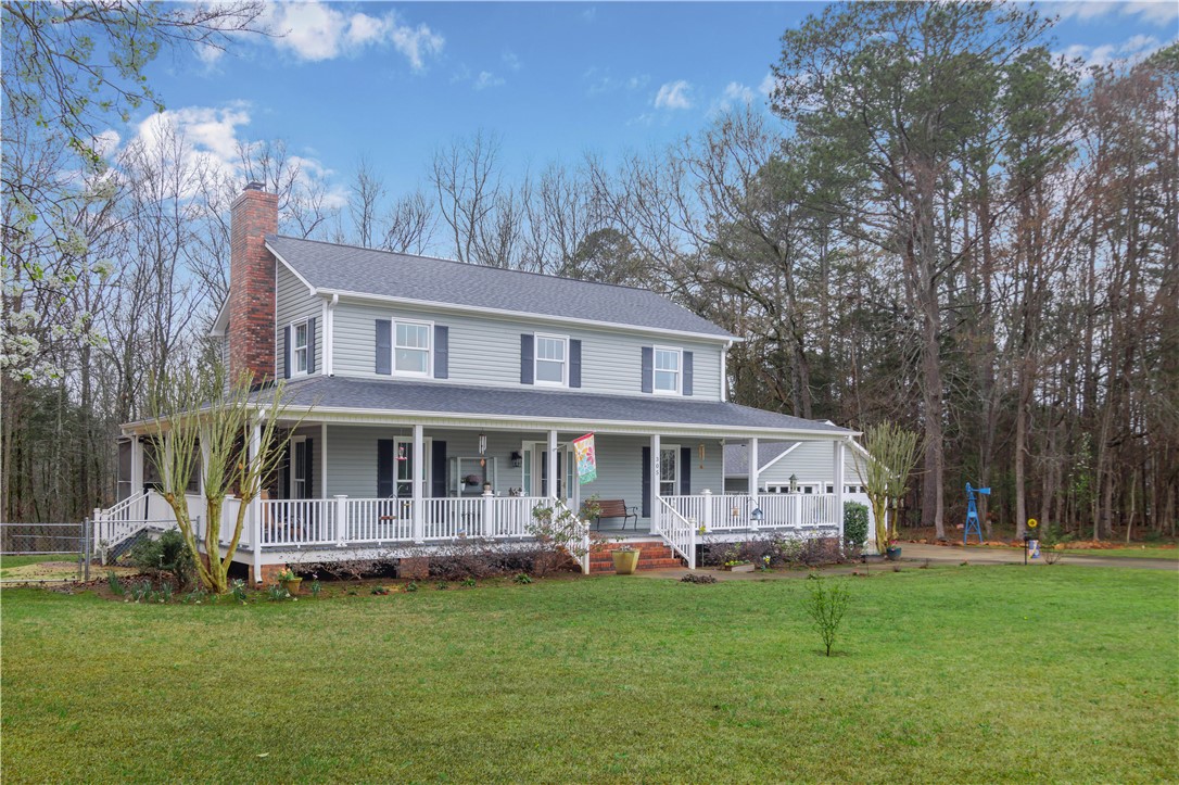 305 Farmdale Road Hodges, SC 29653 - Photo 3 of 48 This classic home offers a full-length porch, perfect for enjoying outdoor moments.