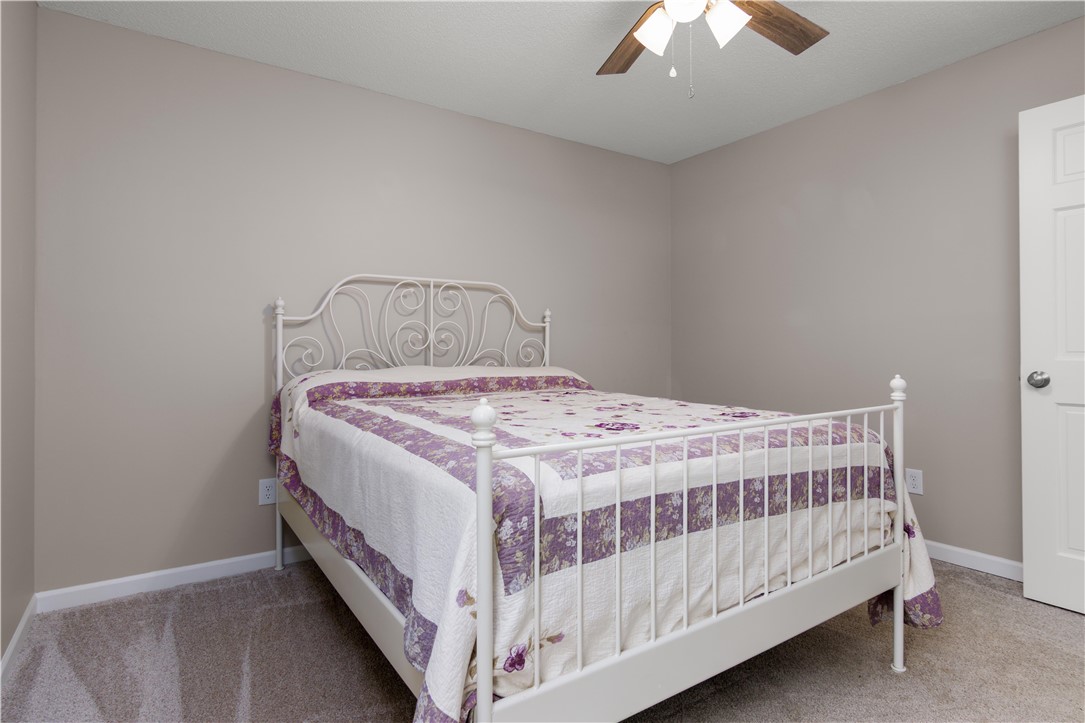 305 Farmdale Road Hodges, SC 29653 - Photo 31 of 48 Comfortable bedroom with soft carpeting and ample natural light invites restful living.