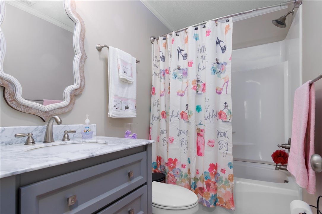 305 Farmdale Road Hodges, SC 29653 - Photo 32 of 48 This bathroom features a sleek vanity and a classic shower-tub combination.