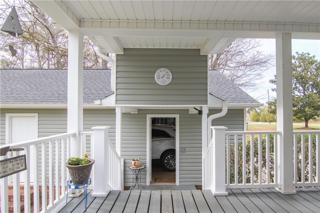 305 Farmdale Road Hodges, SC 29653 - Photo 34 of 48 This inviting covered porch features durable decking and clean white railings.