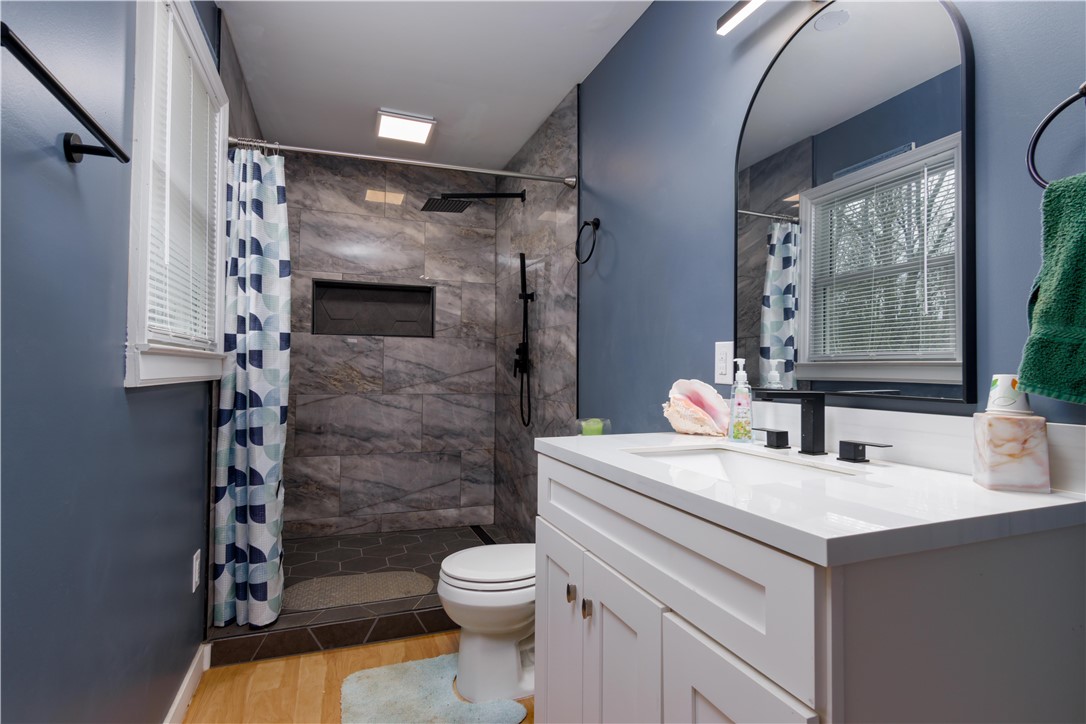 305 Farmdale Road Hodges, SC 29653 - Photo 36 of 48 This modern bathroom features a stylish vanity, a spacious shower, and elegant tile work.
